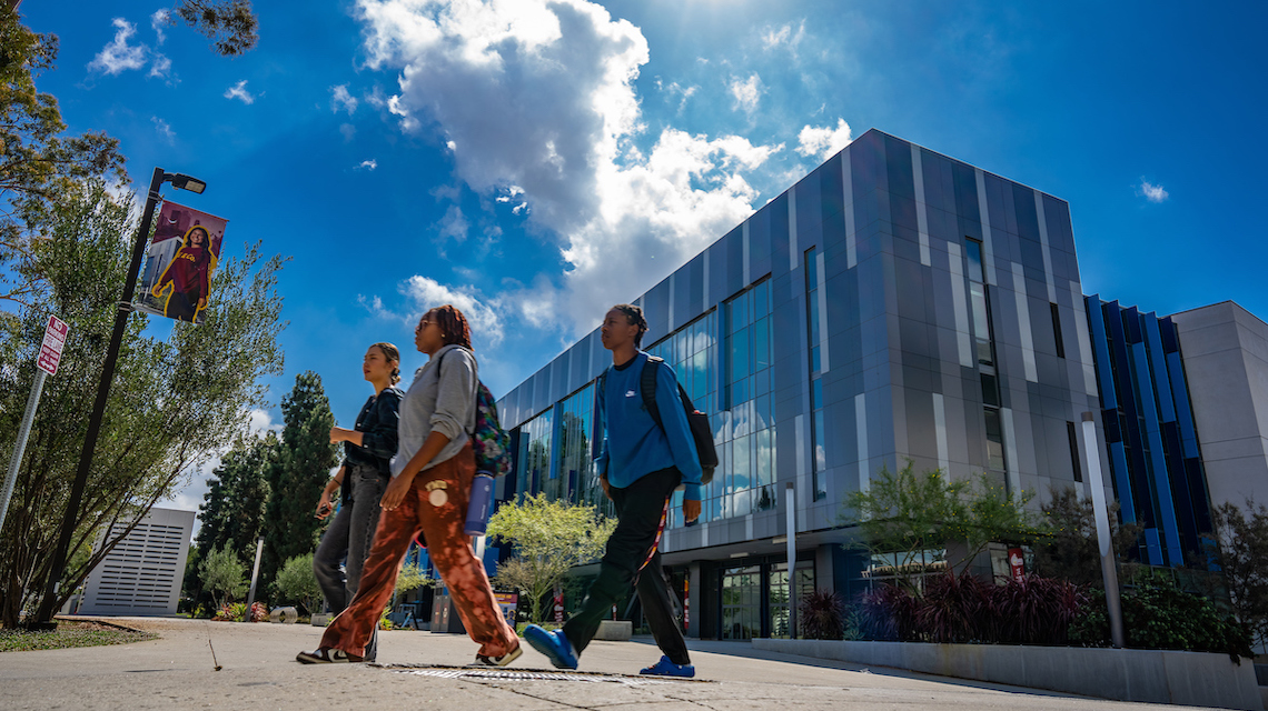 Students walking on campus by the Science and Innovation Building