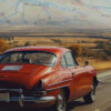 A red car on an open road in the countryside