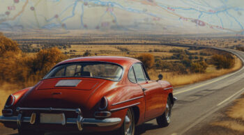 A red car on an open road in the countryside