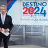 Univision anchor in front of sign reading "Destino 2024"