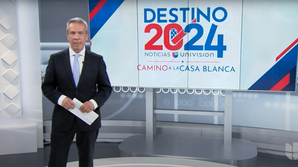 Univision anchor in front of sign reading "Destino 2024"