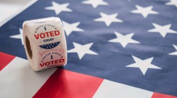 Roll of "I voted" stickers on an American flag