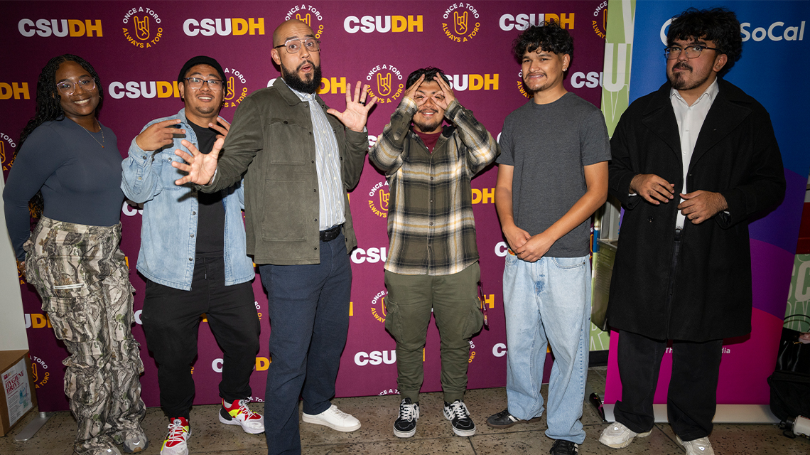 Comedian Jesus Trejo poses with CSUDH students on campus.