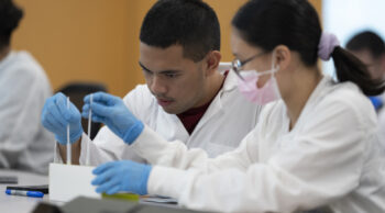 Clinical science students working in a lab on campus.