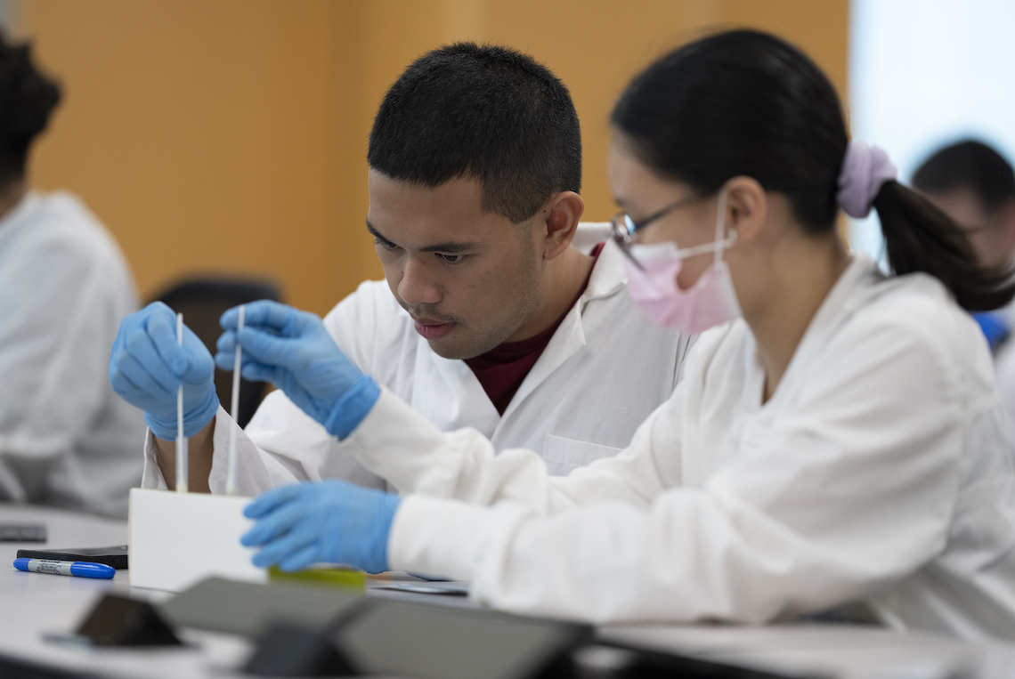 Clinical science students working in a lab on campus.