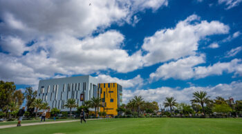 Campus shot of I&I building with blue sky and clouds