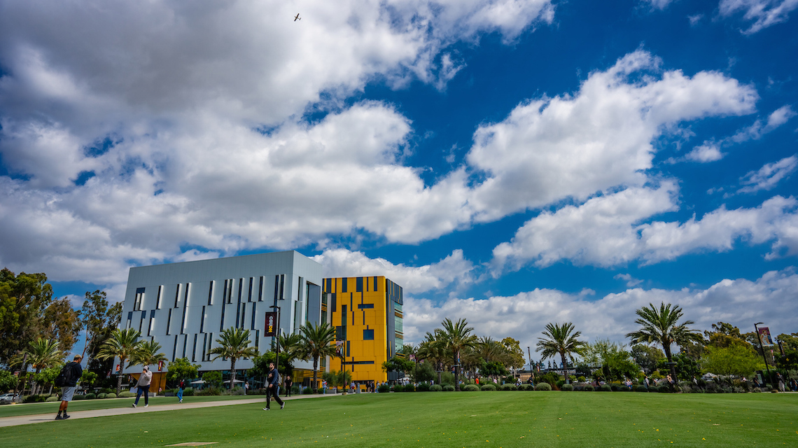 Campus shot of I&I building with blue sky and clouds