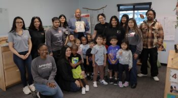 Group pose with children and adults at Child Development Center