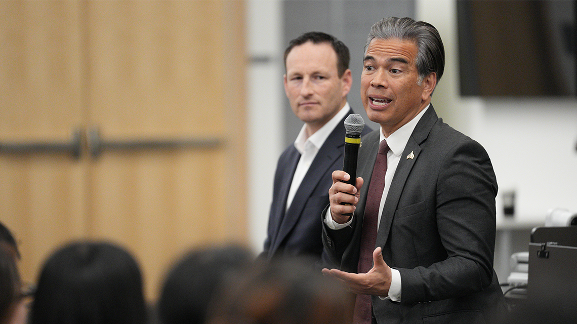 California AG Rob Bonta, right, and Josh Fryday during a campus visit on Feb. 6, 2025.