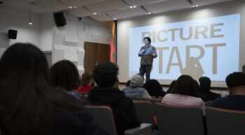 Jef Sewell onstage in front of an audience