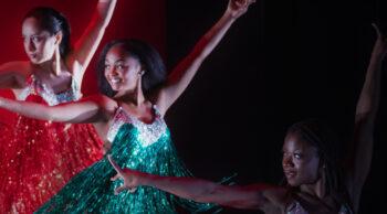 Three dancers in colorful costumes