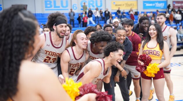 Toro men's basketball team celebrating on court