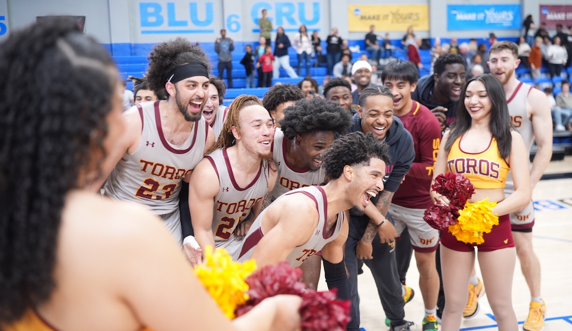 Toro men's basketball team celebrating on court