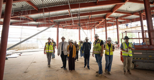 Construction workers and CSUDH leadership at building site