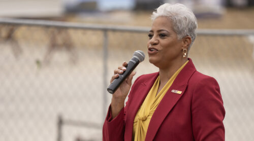 Vice President of Administration and Finance Deborah Wallace speaking at a CSUDH podium on site
