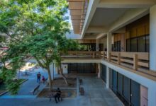 People in the shade of a campus building