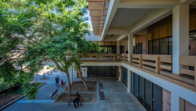 People in the shade of a campus building