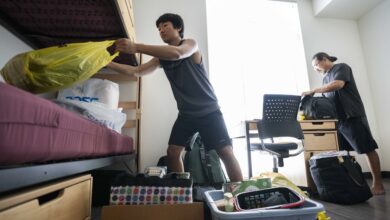 A student and family member setting up his new room.