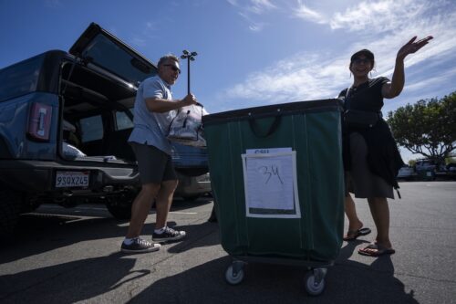 Parents loading up a cart for move-in day.