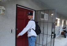Rafael about to open a front door to a residence.