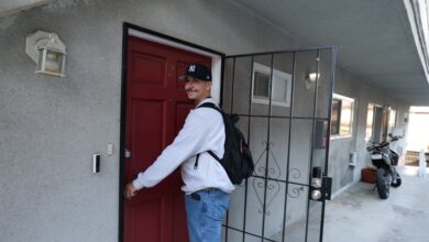 Rafael about to open a front door to a residence.