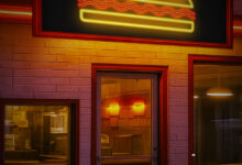 An empty diner lit by neon lights at night