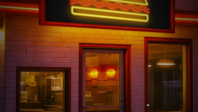 An empty diner lit by neon lights at night