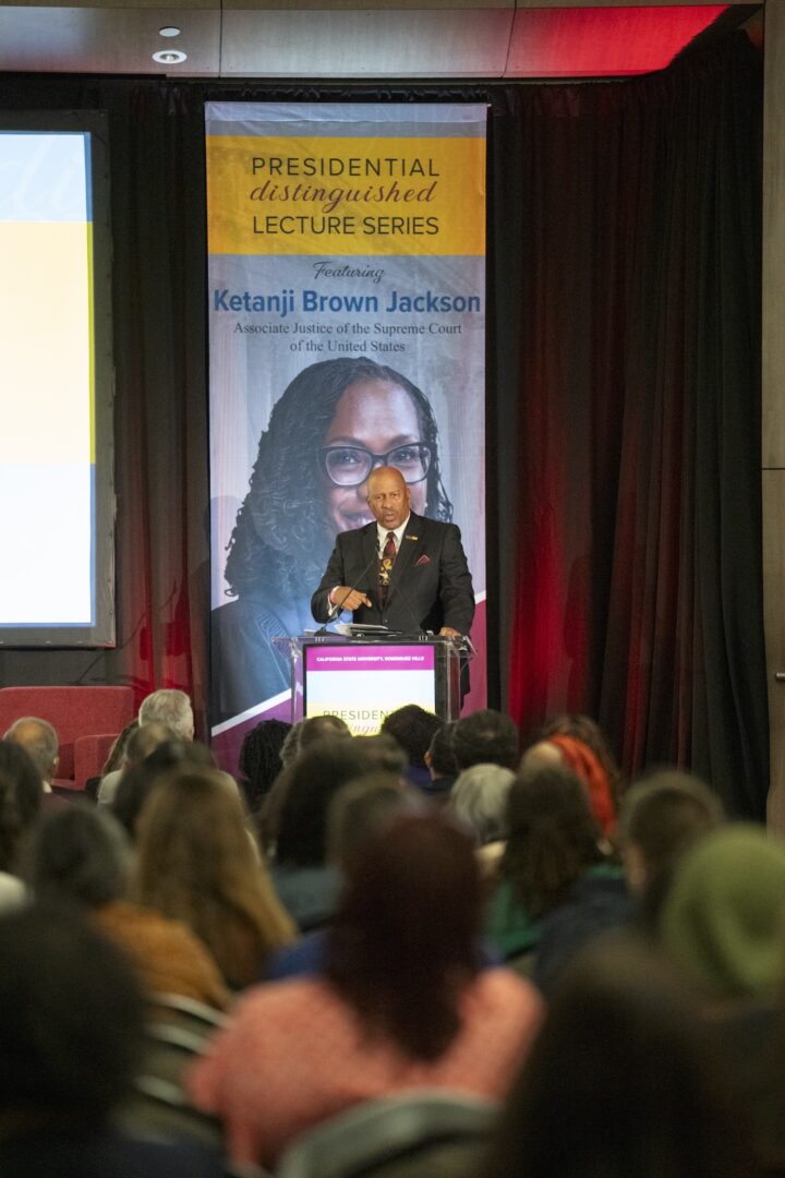 President Parham at podium onstage during event