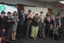 People in CSUDH hats making Toro hand signals