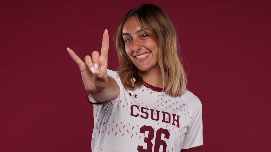 CSUDH soccer player doing Toro hand signal