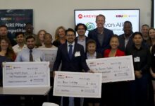 Smiling winners and participants with checks