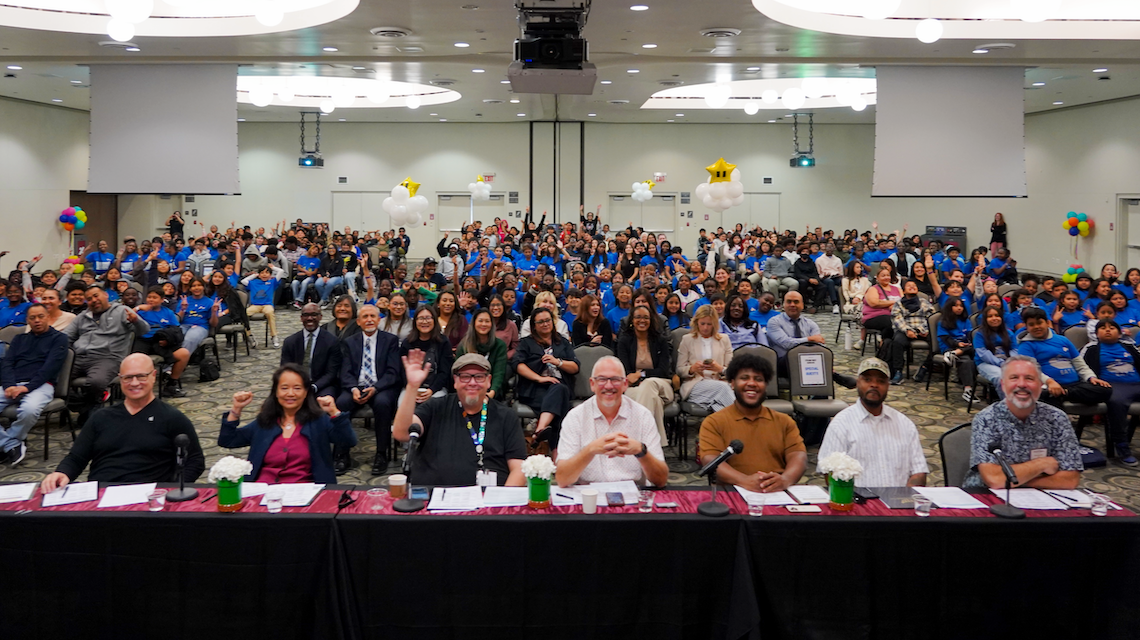 Photo of LSU ballroom showing showcase judging panel and attendees