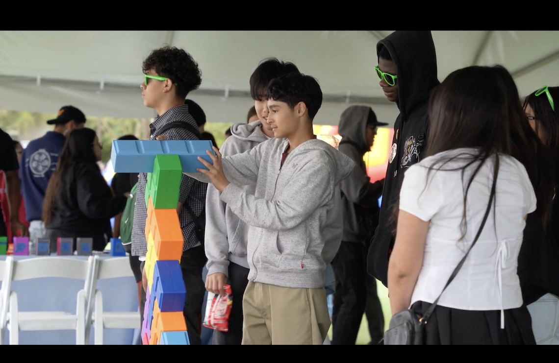 Students stacking blocks