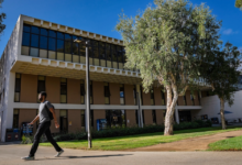 Student walking in front of LaCorte Hall