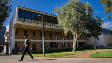 Student walking in front of LaCorte Hall